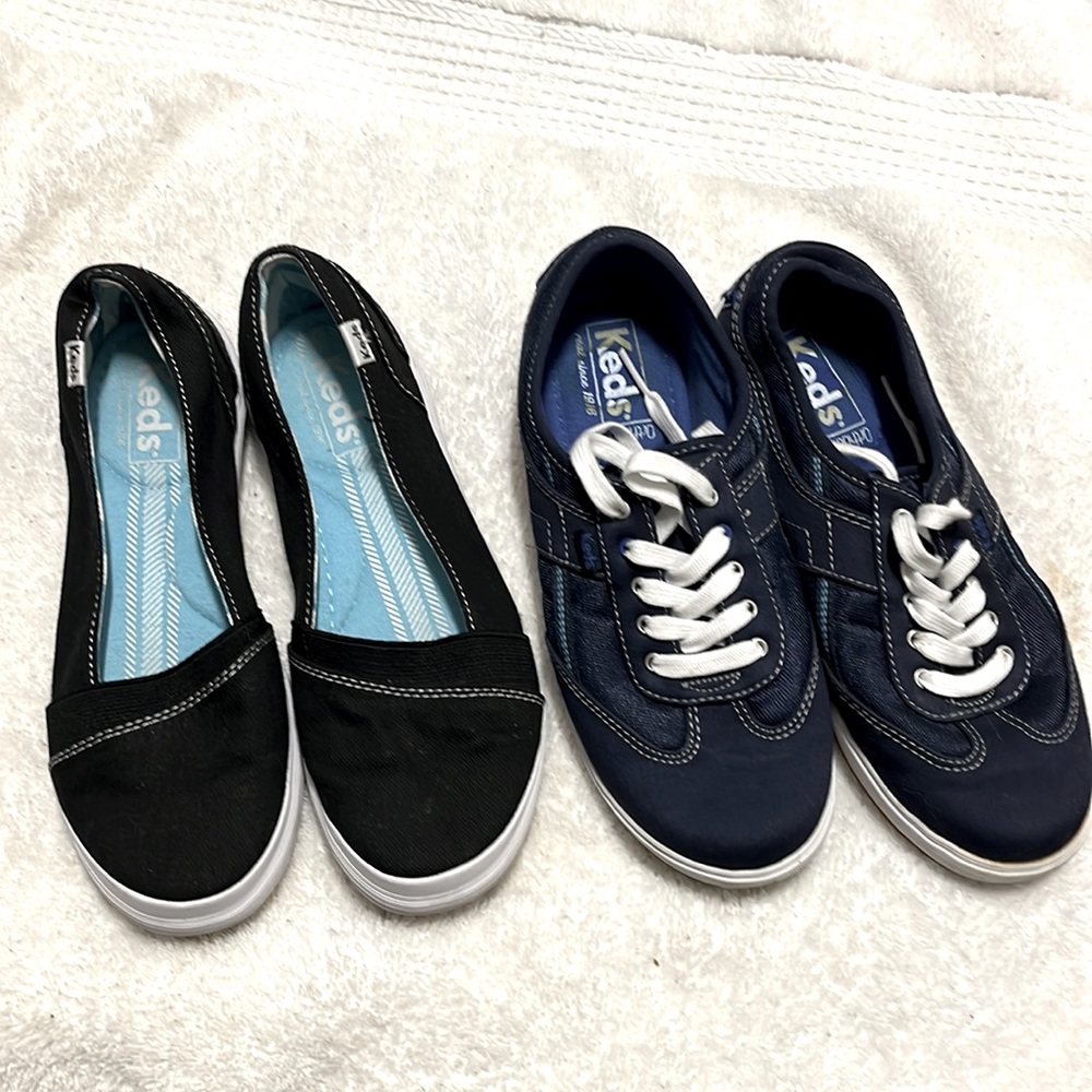 Two pairs of Keds sneakers. One blue laced and black slip on. Both size 5.